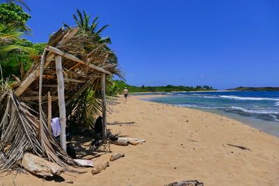 Scenic view of beach against clear blue sky