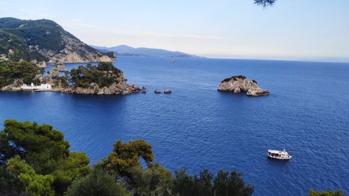 Scenic view of sea and mountains against sky