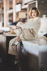 Portrait of young woman sitting indoors