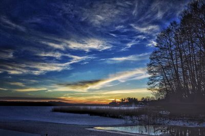 Scenic view of lake against sky during winter