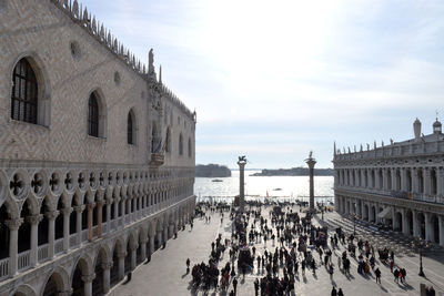 Group of people in historic building against sky