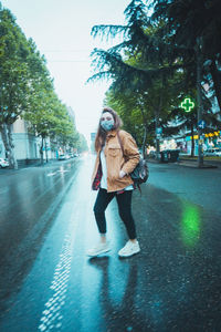 Full length of young woman walking in city