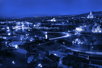 High angle view of illuminated buildings in city at night