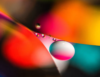 Close-up of water drops on multi colored glass