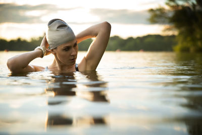 Thoughtful female swimmer in lake