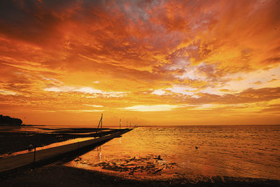 Scenic view of sea against orange sky