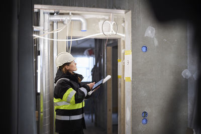 Female engineer using digital tablet at building site