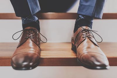 Low section of businessman sitting on steps