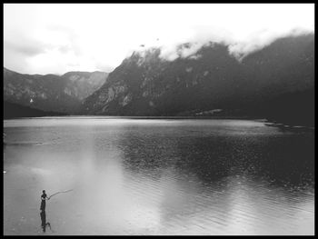 Scenic view of lake against cloudy sky