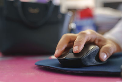 Close-up of person using mobile phone on table