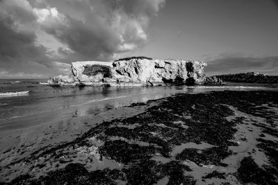 Scenic view of sea against cloudy sky