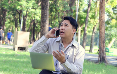 Man using mobile phone in garden