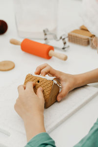 A child is making a gingerbread house in the kitchen. christmas holidays