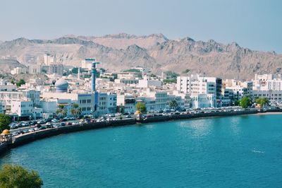 High angle view of sea and cityscape against sky