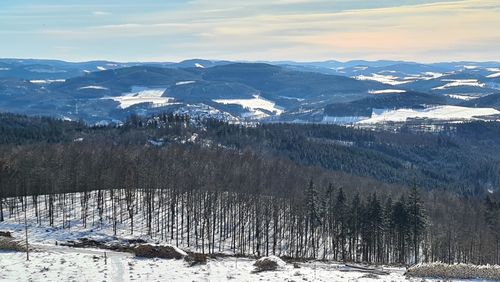 Scenic view of snow covered mountains against sky