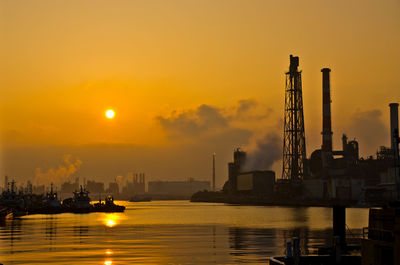 Commercial dock against sky during sunrise