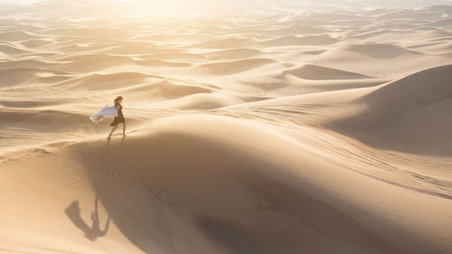 High angle view of woman walking in desert