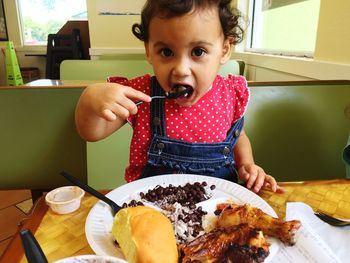 Boy eating food in plate