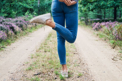 Midsection of woman standing on purple land