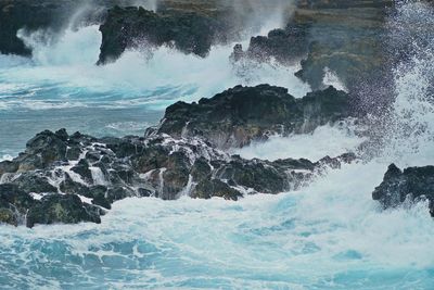 Waves splashing on rocks at shore