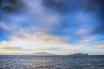 Scenic view of sea against cloudy sky