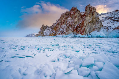 Frozen lake against sky during winter