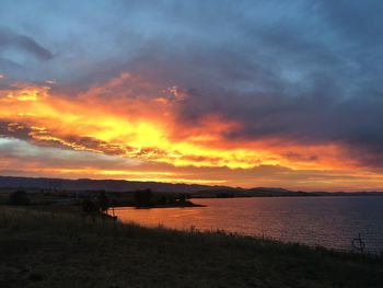 Scenic view of lake against cloudy sky