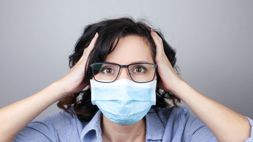 Close-up portrait of young woman wearing protection face mask