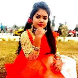 Portrait of young woman sitting outdoors