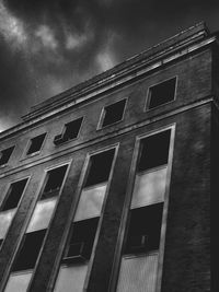 Low angle view of building against cloudy sky