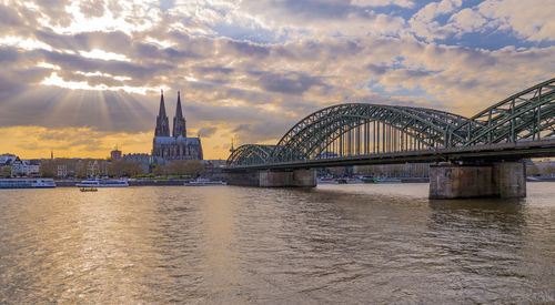 View of bridge over river against cloudy sky