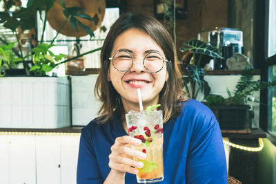 Portrait of smiling woman holding ice cream