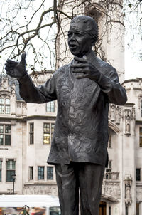 Statue of man with sculpture in background