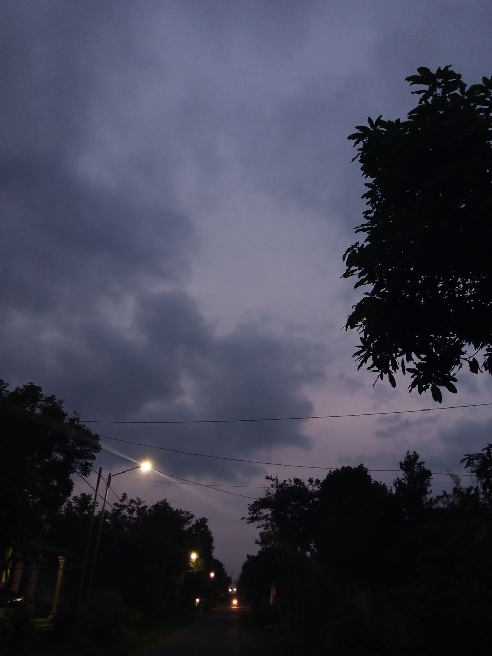 sky, tree, plant, cloud, darkness, nature, dusk, evening, no people, silhouette, street, night, beauty in nature, light, road, transportation, illuminated, outdoors, city, storm, dark, sunset, architecture, scenics - nature, car, tranquility, environment