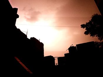 Low angle view of silhouette buildings against sky during sunset
