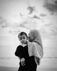 Boy standing against sky