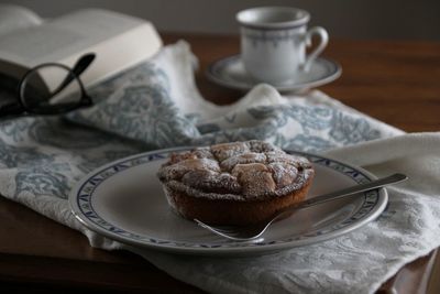 Dessert and spoon in plate on table