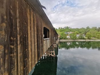 Scenic view of lake by building against sky