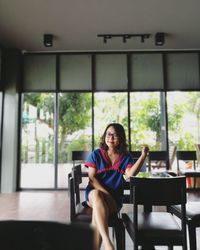 Portrait of businesswoman sitting on chair in office