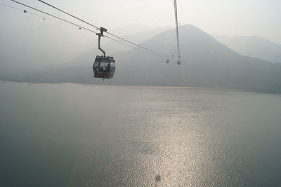 Overhead cable car over snow covered mountains
