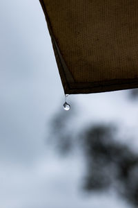 Close-up of water falling from roof