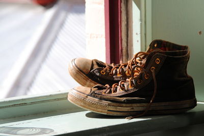 Close-up of shoes by window