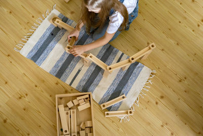 High angle view of woman working on hardwood floor at home