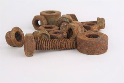 Close-up of rusty metal against white background