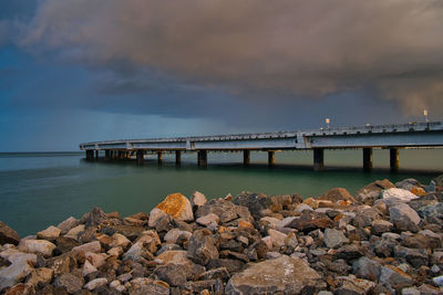 Bridge over sea against sky