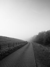 Empty road along countryside landscape