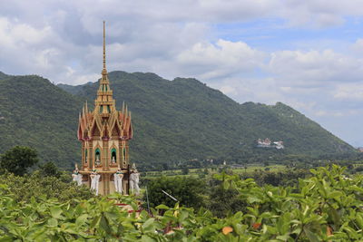 Temple by building against sky