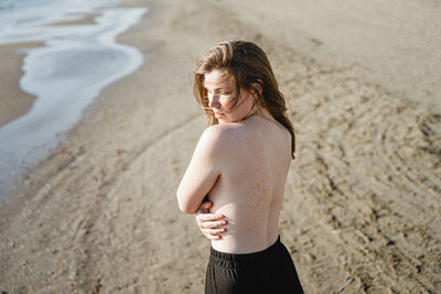 Seductive woman standing at beach