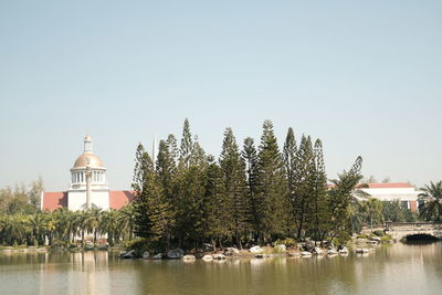 Panoramic view of lake by building against clear sky