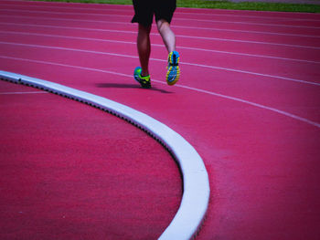 Low section of man running on running track